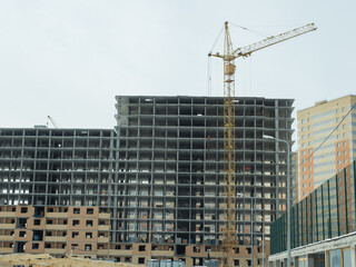 Urban Construction Site with High-Rise Building and Yellow Crane