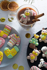 Christmas marshmallows. Winter candy. Sweet food in december. Bear in Santa Claus hat
