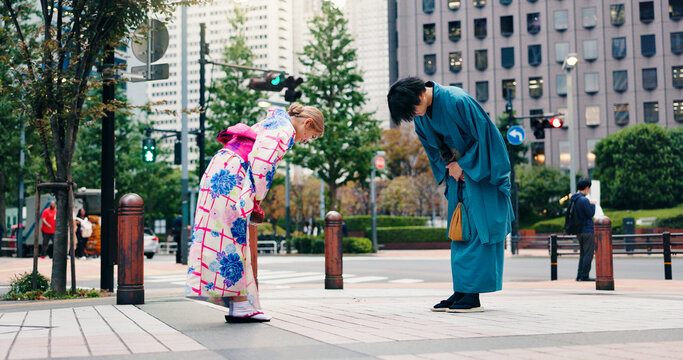 Respect, japanese people and bow for greeting, culture and welcome with kimono in city. Traditional fashion, man and woman with introduction in urban town for honor, departure and farewell custom