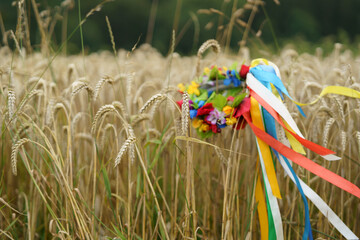 Traditional Ukrainian national wreath on ripe ears of wheat. Concept of Ukrainian tragedy