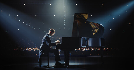 Male Pianist Sits Down at Black Grand Piano, Playing a Mesmerizing Jazz Melody. Audience Watching the Musician Play on Stage. Artist is Focused on Creating Beautiful Instrumental Sonata © Gorodenkoff