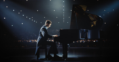 Classical Piano Concert: Under the Spotlight, Pianist Delivering a Powerful Performance on the Grand Piano. Elegant Stage Setting Complements His Passionate Playing, Leaving the Audience Happy © Gorodenkoff