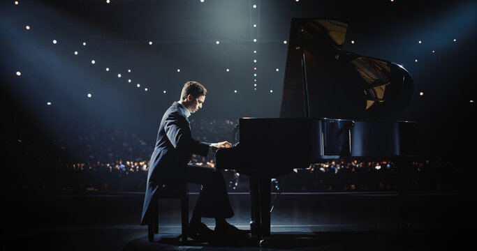 Classical Piano Concert: Under the Spotlight, Pianist Delivering a Powerful Performance on the Grand Piano. Elegant Stage Setting Complements His Passionate Playing, Leaving the Audience Happy