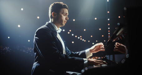 Classical Piano Concert: Under the Spotlight, Pianist Delivering a Powerful Performance on the Grand Piano. Elegant Stage Setting Complements His Passionate Playing, Leaving the Audience Happy