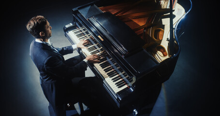 Classical Piano Concert: Pianist Delivering a Powerful Performance on the Grand Piano. Elegant Stage Setting Complements His Passionate Playing, Leaving the Audience Captivated. High Angle