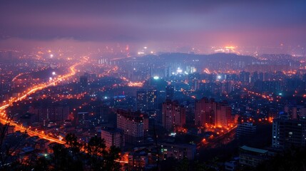 Obraz premium A vibrant cityscape at night, showcasing illuminated buildings and winding roads.