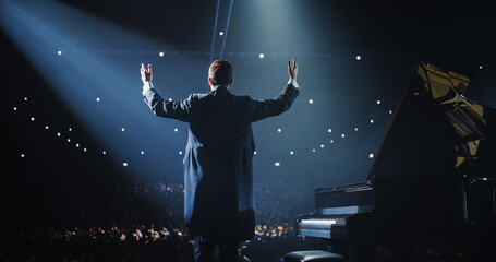 Pianist, Standing Proudly on Stage, Takes a Moment to Thank the Audience. He is Looking Straight at...