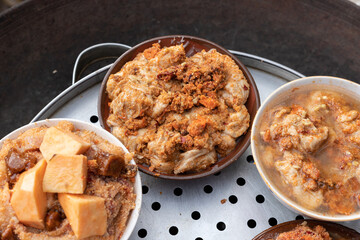 Steamed stuffed tofu and pig's intestines in a bamboo basket