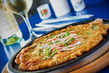 a fried scallion pancake topped with imitation crab meat © James
