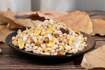 Mixed cereal with nuts and dried fruits on a plate