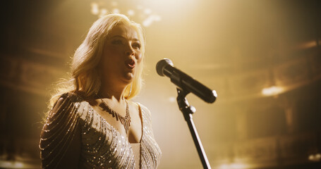Pop Singer Performing on a Live Concert Stage. Portrait of an Adult Female Wearing a Striking Dress...