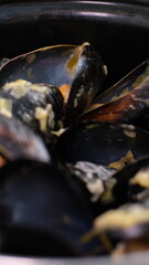 saucepan with mussels with cream sauce and tasty bread with garlic and spices. table of restaurant. 