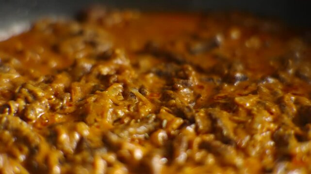 Cooking Beef Stroganoff With Meat In Creamy Tomato Sauce With Spices In Pan. Preparing Hot Stew Gravy Goulash