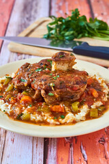 osso bucco beef shank topped with a tomato gravy served on mashed potatoes