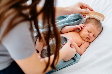 Peaceful newborn baby receiving gentle care from parent
