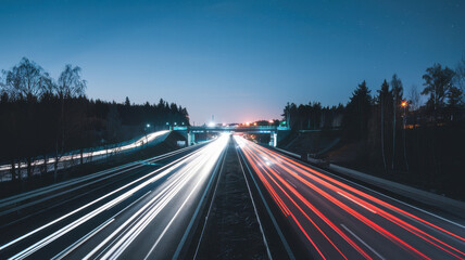 A mesmerizing twilight scene of a highway, showcasing streaks of headlights and taillights, creating a dynamic contrast against the night sky.