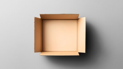 Top view of an open empty cardboard box with flaps extended on a neutral background