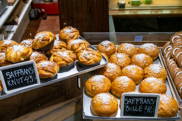 Stockholm, Sweden An assortment of freshly baked saffron buns and pepparkakor in a bakery window.