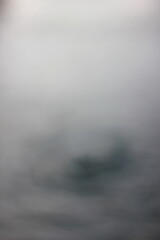 A dreamy blurry view of ripples in the water.