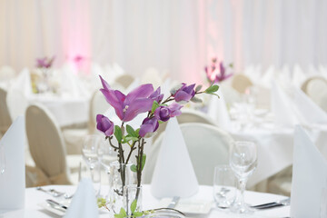 Elegant dining setup featuring floral arrangements for a special event in a beautifully decorated venue