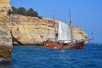Albufeira Beach and boating, Portugal, Europe. Tourist are sightseeing by boating in the water of...