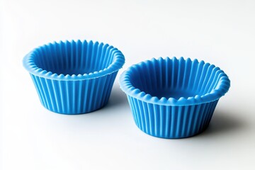 Pair of blue silicone cupcake molds on a white surface