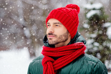 Photo of pretty confident young gentleman wear windbreaker walking snowy weather smiling outside...