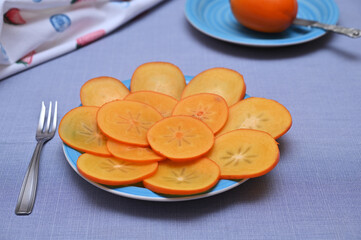 still life with sliced ​​persimmons on the table