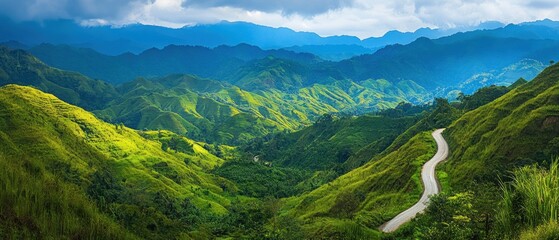 Lush green hills with a winding road under a cloudy sky, showcasing natural beauty.