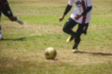 blurry image of amateur soccer players in action outdoor match