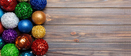 Top view decorative balls in rows on wooden background. Christmas toys concept with empty space for your design