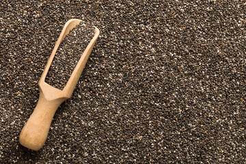 Space for text Texture of chia seeds with wooden spoon, superfood concept. Top view