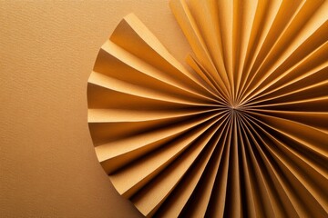 Golden paper fan art displayed against a textured background showcasing intricate folds and patterns