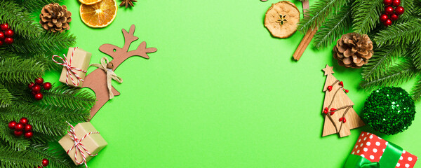 Top view of Christmas decorations on green background. New Year holiday concept with copy space