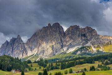 Dolomites mountains nasty weather in autumn with dark cloudy sky before the storm. Black clouds on the sky above the mountain rocky summits and peaks, stormy weather in the Dolomiti Alps, Italy