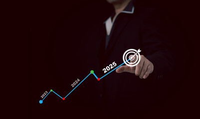 Businessman point a target  with a virtual display showing a 2025 growth projection graph. Represents future business trends, technology, and financial planning..
