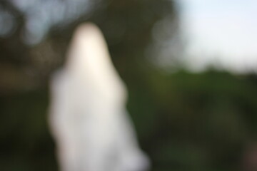 A dreamy view of a water fountain spounting in the park.