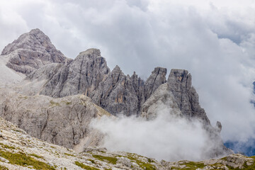 Dolomites mountains nasty weather in autumn with dark cloudy sky before the storm. Black clouds on the sky above the mountain rocky summits and peaks, stormy weather in the Dolomiti Alps, Italy