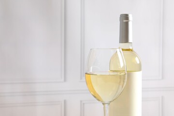 Bottle of white wine with glass