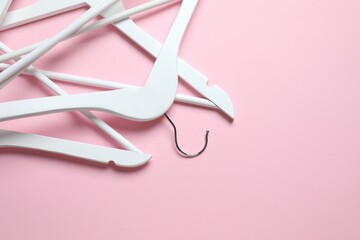 Wooden clothes hanger on a colored background