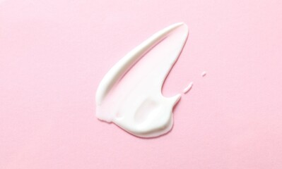 Smear of cream on a colored background