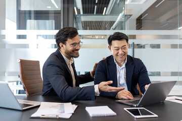 Business professionals collaborate in office laptop, showing teamwork, communication, and...