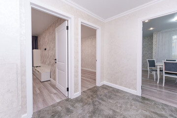 white doors in the hallway and room in a modern apartment
