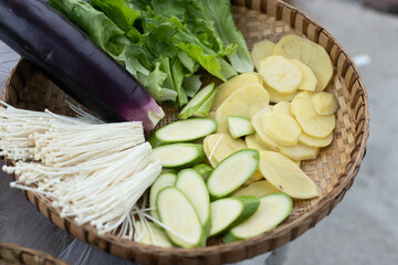 Fresh grilled vegetable ingredients in a bamboo sieve