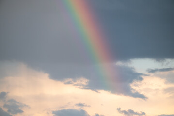 Rainbow in sky with dramatic clouds. Beautiful colorful sky after the rain