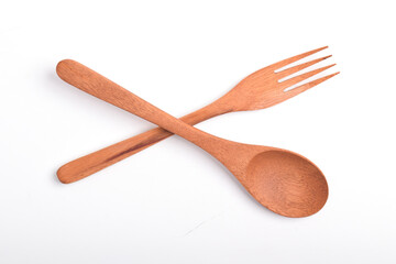 Wooden spoon and fork, crossed as road sign, isolated on white background. Houseware