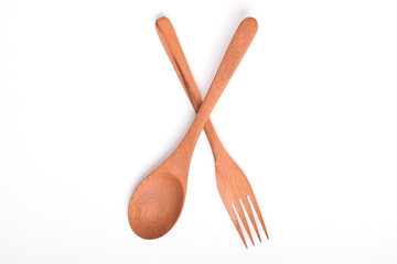 Wooden spoon and fork, crossed as road sign, isolated on white background. Houseware