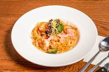 Mentaiko Shrimp and Avocado Spaghetti served in plate isolated on wooden table side view of italian cousin