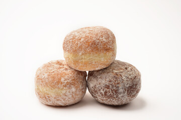 Close up photograph of three doughnuts isolated on white background. Food objects. 