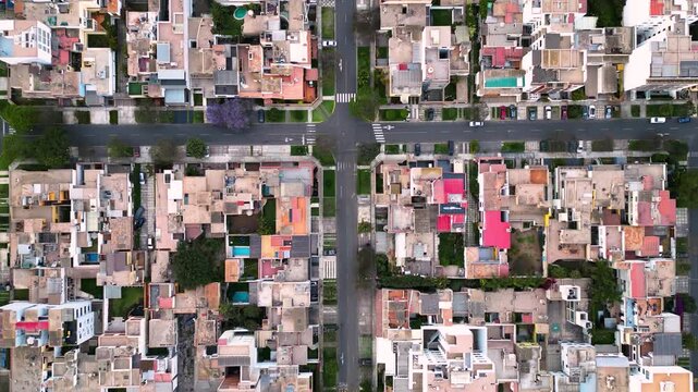 Vista cenital de una ciudad sudamericana en una tarde tranquila, con calles transitadas de tr&aacute;fico ligero y casas envejecidas
